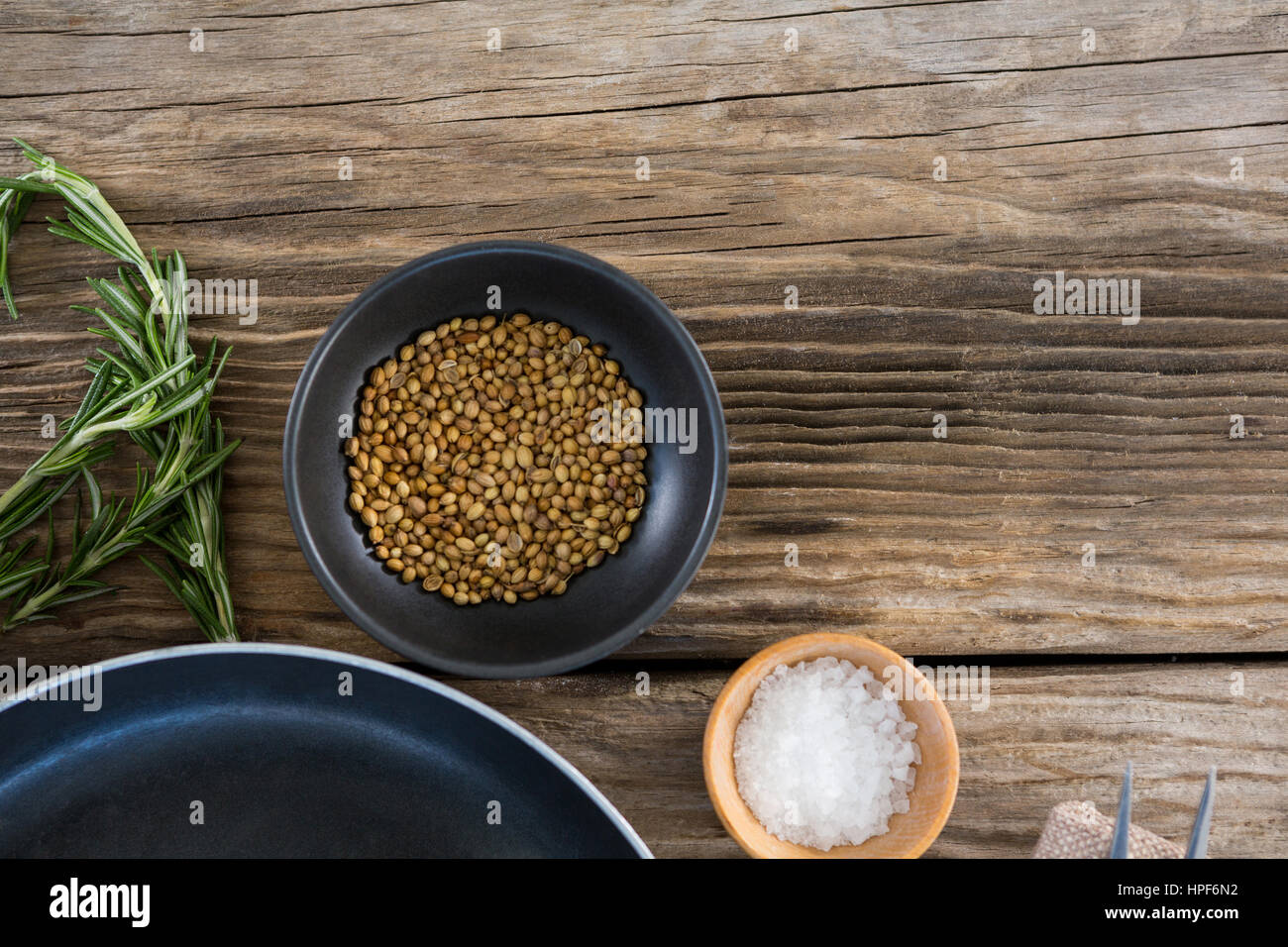 Koriander Samen, Salz und Rosmarin Kräuter aus Holz Hintergrund Stockfoto
