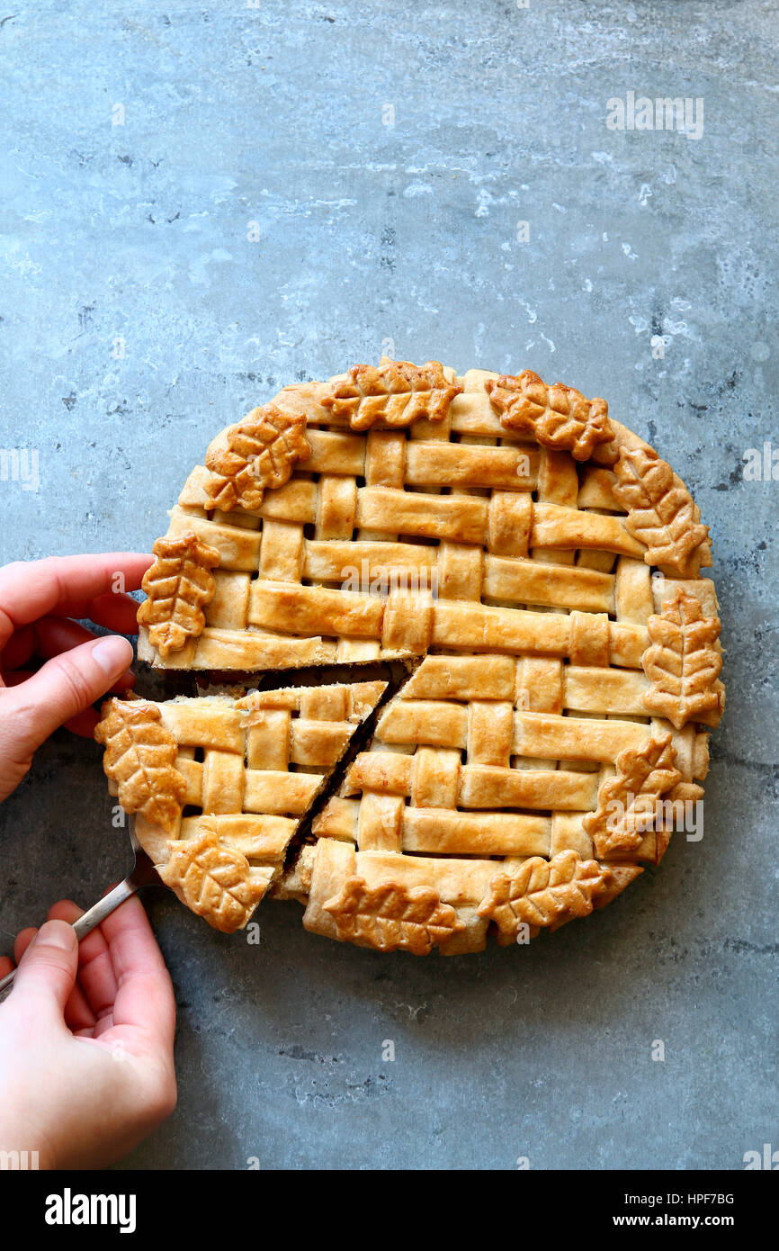 Weiblich, schneiden ein Stück Apfelkuchen. Ansicht von oben. Stockfoto