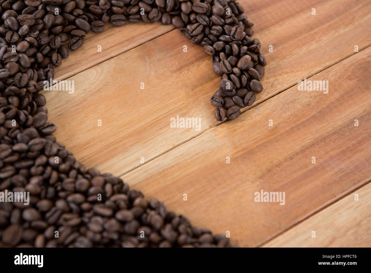 Kaffee Bohnen bilden Form auf Holztisch Stockfoto