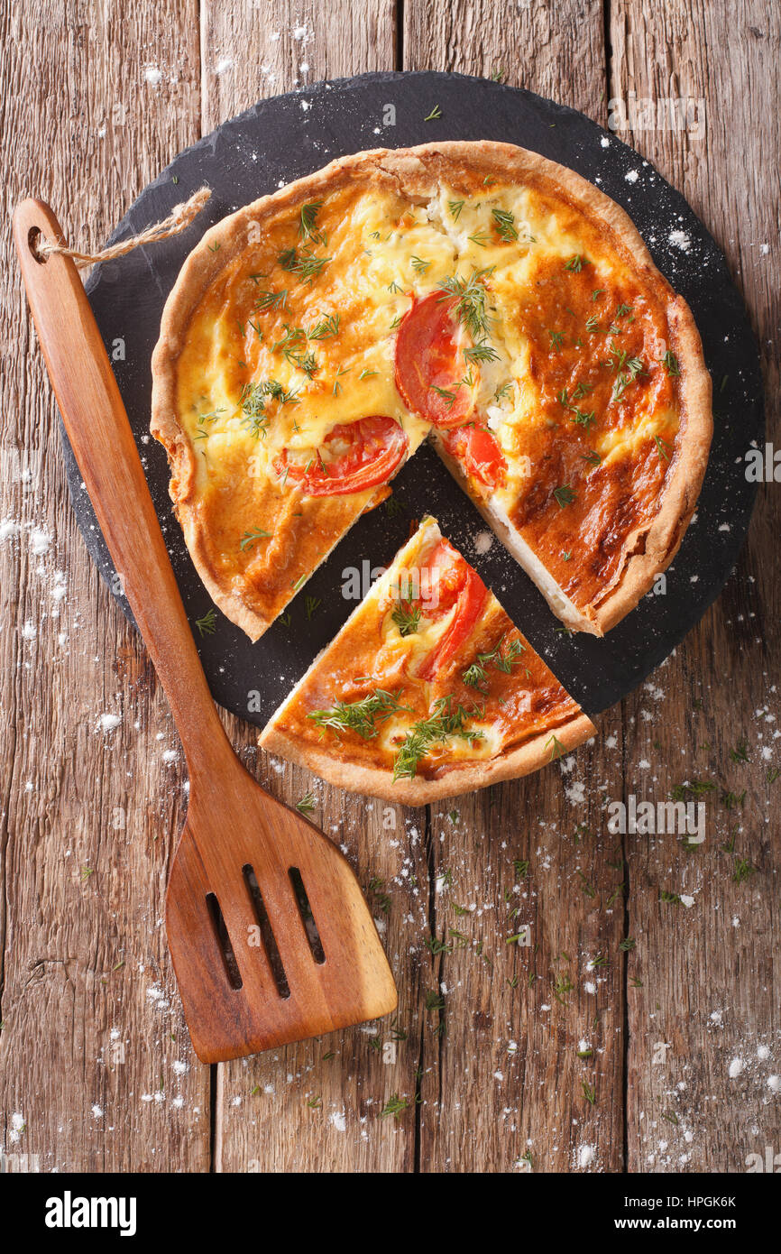 Geschnittenen Torte mit Sahne, Käse, Tomaten und Kräuter Closeup auf dem Tisch. vertikale Ansicht von oben Stockfoto