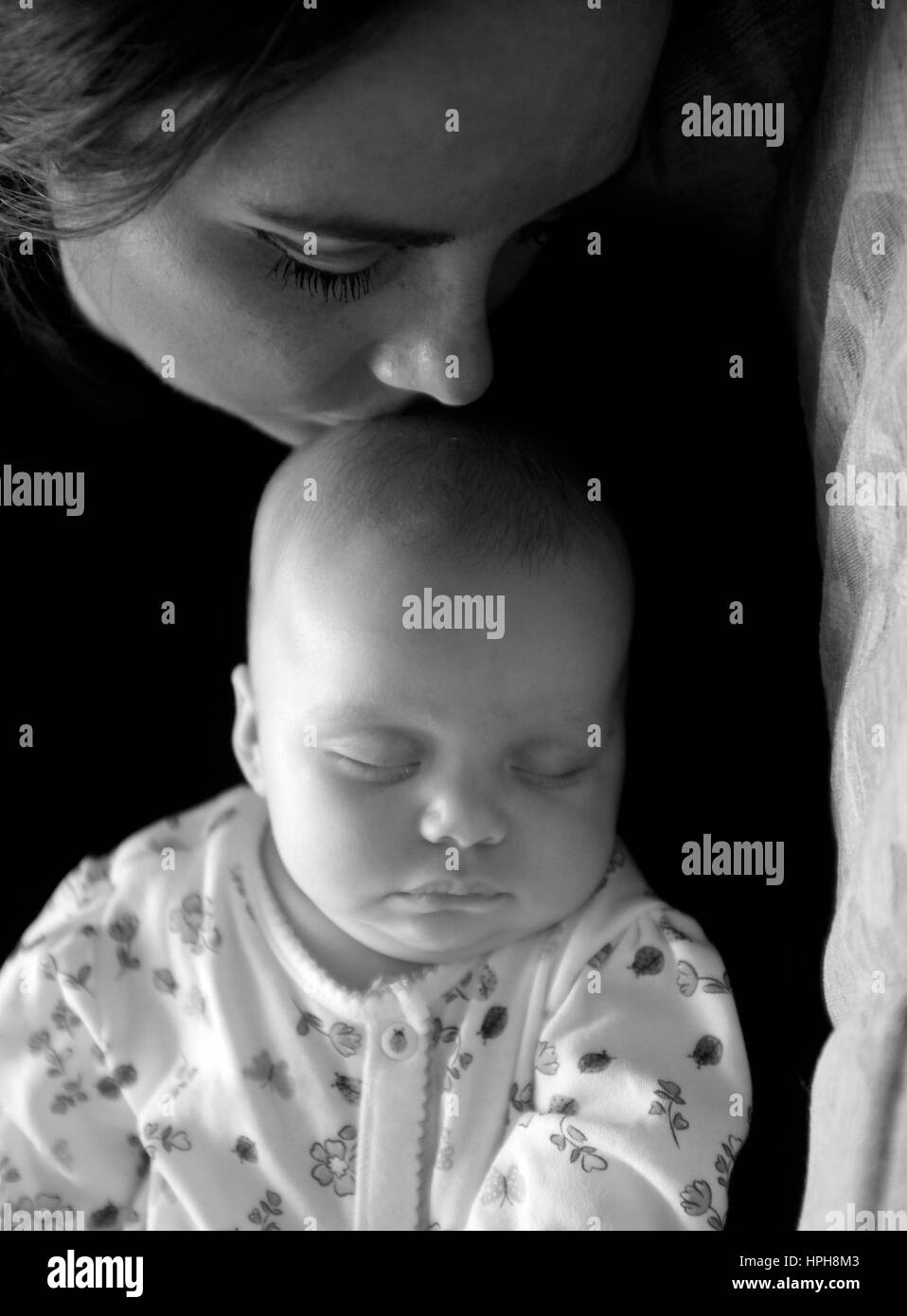 Junge Mutter und ihr Baby schlafen kuscheln Stockfoto
