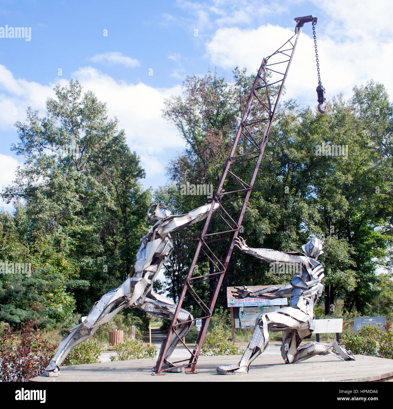 Die muskulöse Chrome Workers Skulptur in Portsmouth, VA, ehrt die Arbeit mit glänzenden Metallfiguren, die Stärke, Geschick und Industriestolz zelebrieren. Stockfoto