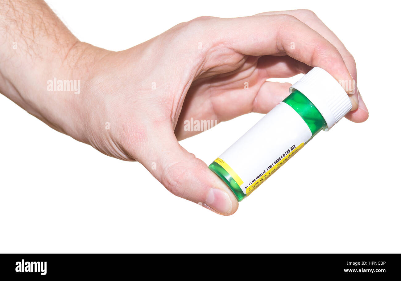 Pille-Container in der Hand isoliert auf weißem Hintergrund Stockfoto