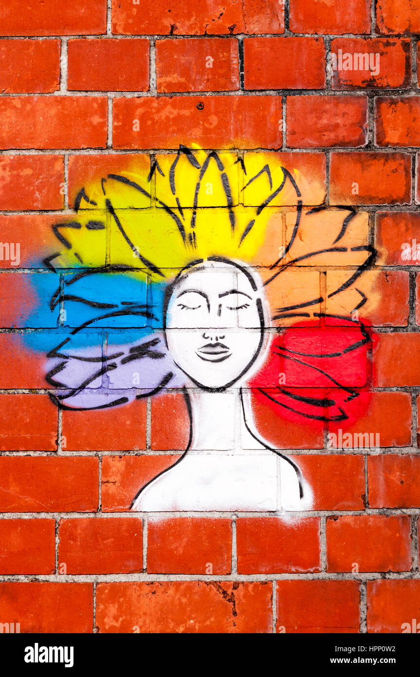 Graffiti von einer Frau mit Regenbogen coloriertes Haar im Afro-Stil. Stockfoto