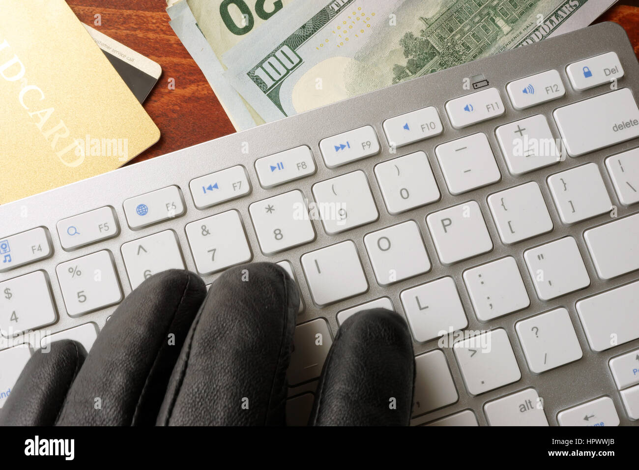 Hacking-Konzept. Hand im schwarzen Handschuh ist auf einer Tastatur tippen. Stockfoto