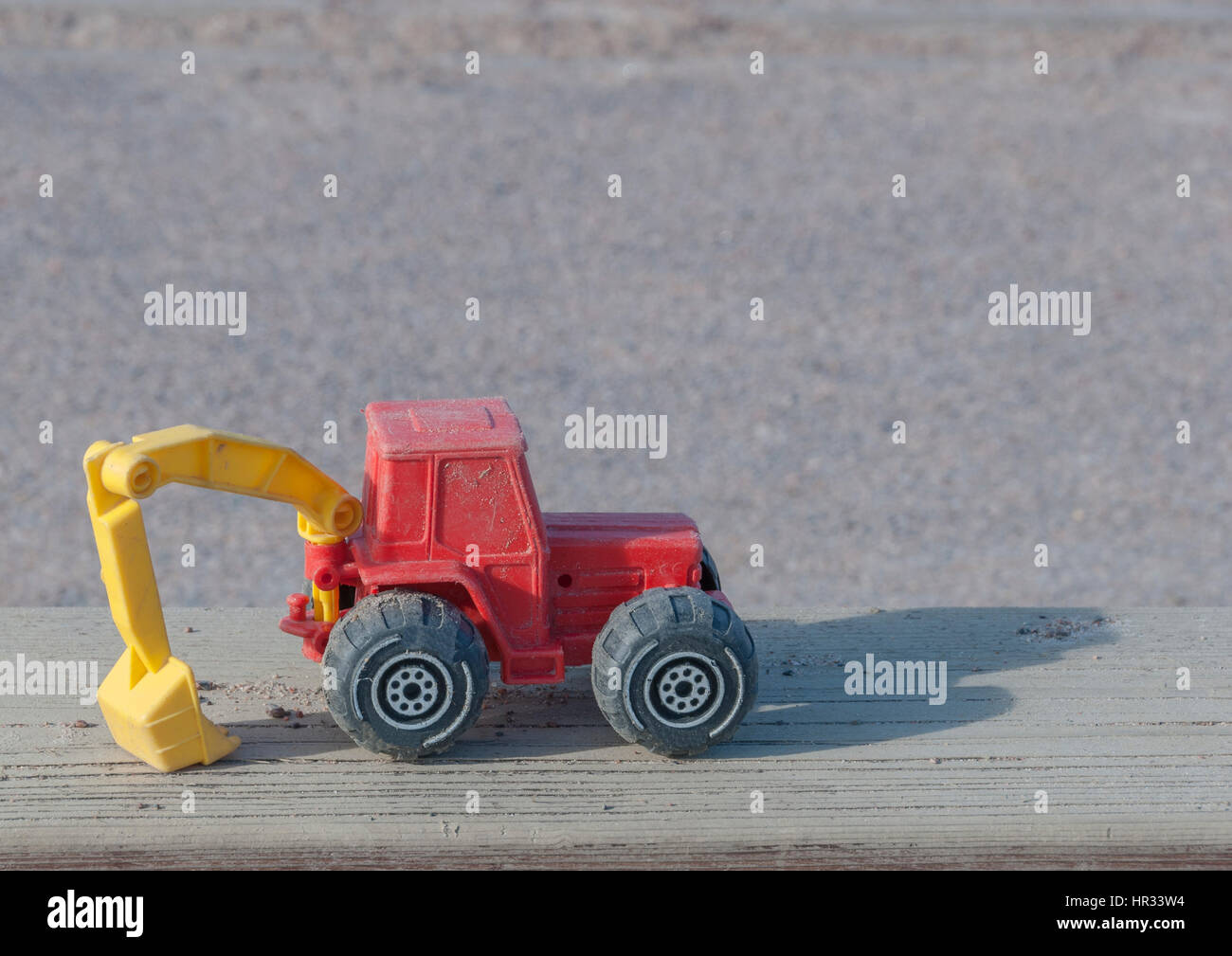 Spielzeug-Bau-Traktor-Hintergrund Stockfoto