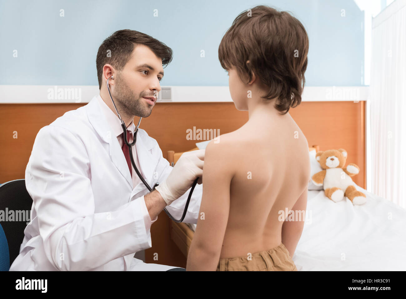 Lchelnder Mann Arzt Mit Stethoskop Shirtless Junge Im Kran