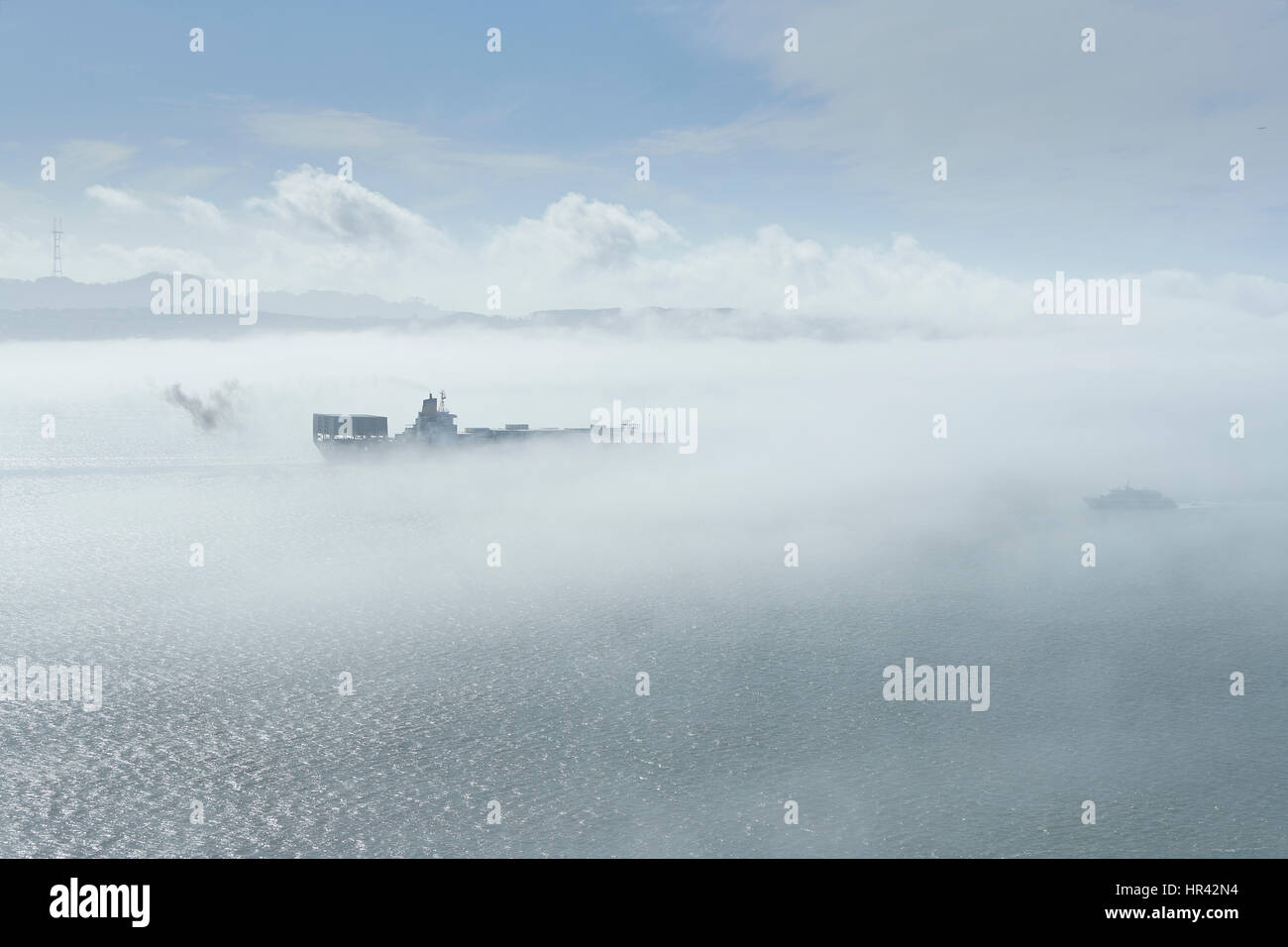 Frachtschiff verlassen die Bucht von San Francisco im dichten Nebel. Stockfoto