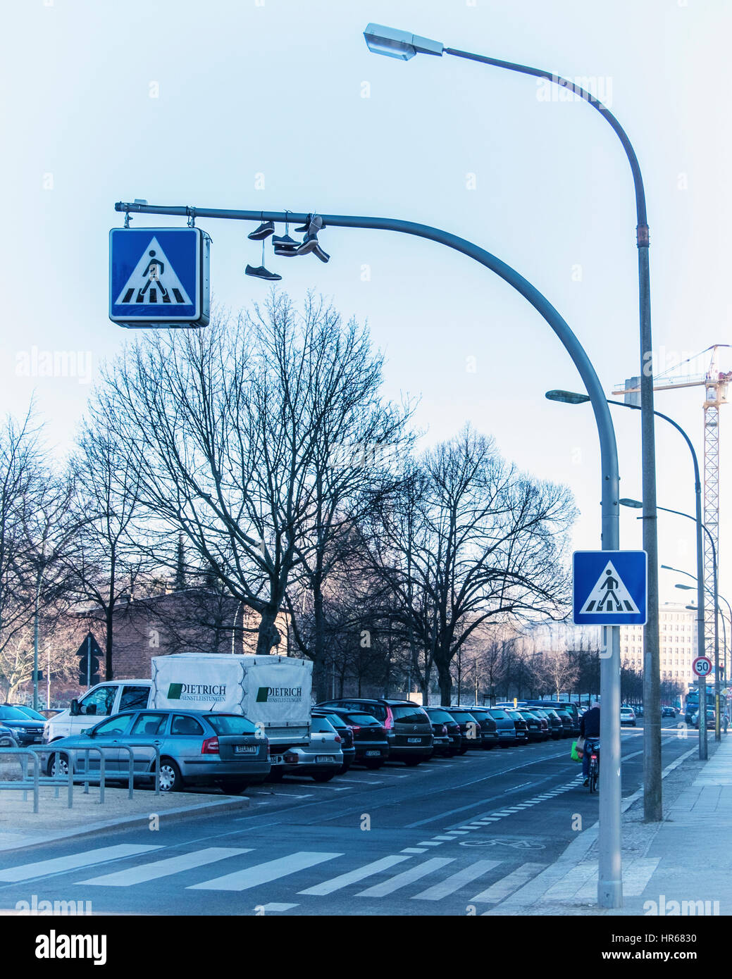 Berlin, Friedrichshain, Friedenstraße. Schuhe, Trainer an einem Fußgängerüberweg Zeichen aufgehängt. Konzept, sind diese Schuhe zum Wandern gemacht. Stockfoto