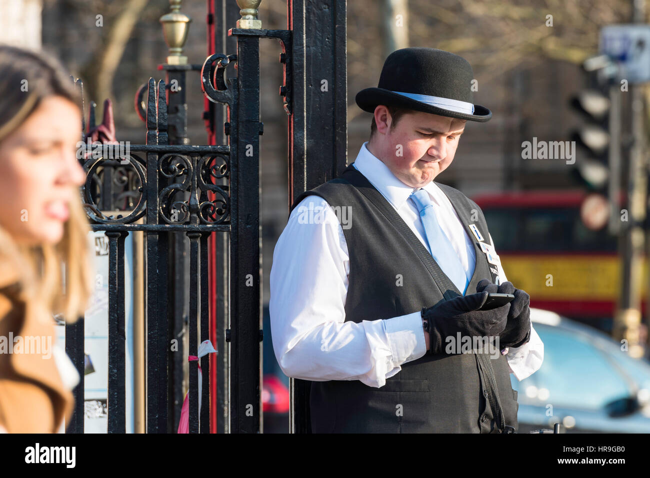 Einen männlichen Reiseführer mit Handschuhen Überprüfung seines Mobiltelefons. Stockfoto