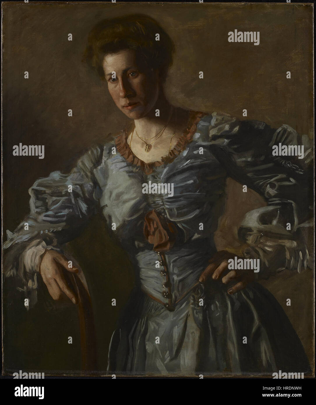 Thomas Eakins, ein amerikanischer Maler, schuf zwischen 1905 und 1906 ein Porträt von Elizabeth L. Burton, das sie in einer Dreiviertel-Figuren-Pose zeigt, mit einem grau-blauen Taftkleid mit schokoladenbraunem Seidenbesatz und ihrem Haar im Pompadour-Stil. Stockfoto
