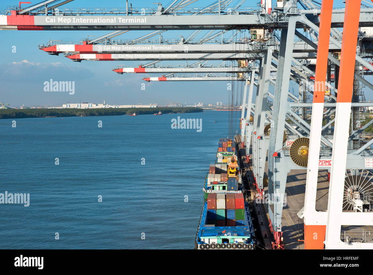 Luftaufnahme des Cai Mep internationalen Terminals in Vietnam mit Behältern, die durch ein (sts)-Ship-to-Shore-Kran entladen wird oder Container-Umschlag-gant Stockfoto