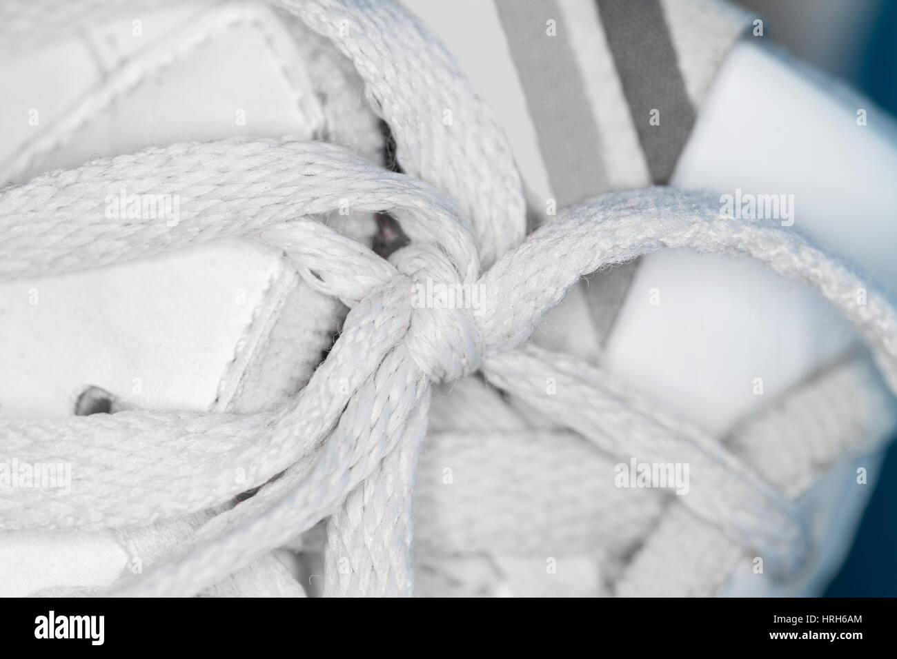 weiße Schnürsenkel Knoten auf weiße Turnschuhe Stockfoto