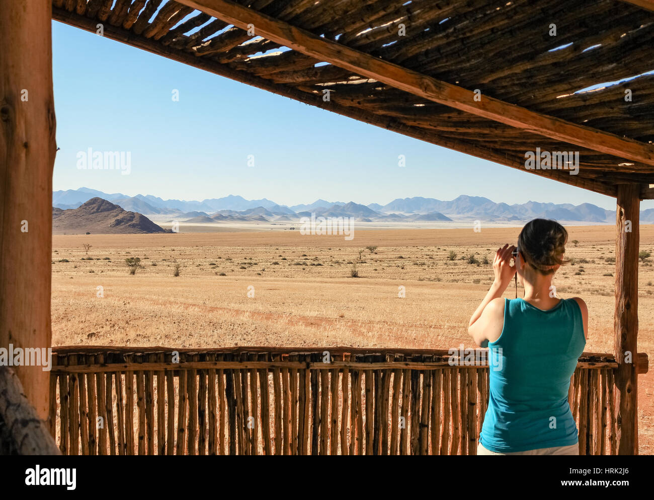 Frau touristische Blick durch ein Fernglas Berge, Wüste, Landschaft zu genießen. Stockfoto