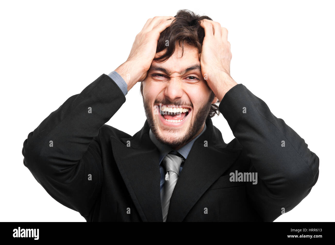 Wütend Geschäftsmann mit Händen in sein Haar, isoliert auf weiss Stockfoto