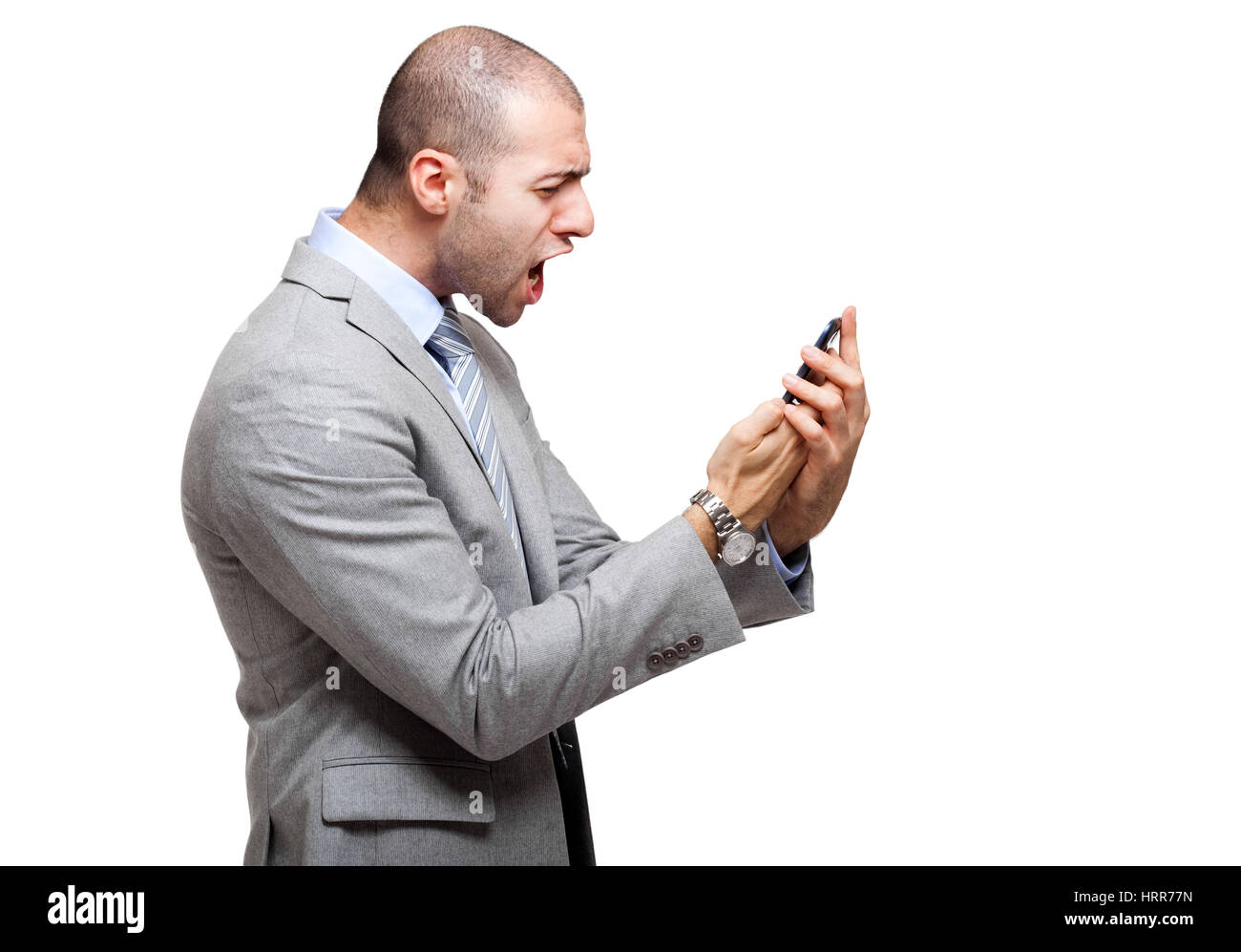 Verärgerter Mann schreiend auf seinem Handy Stockfoto