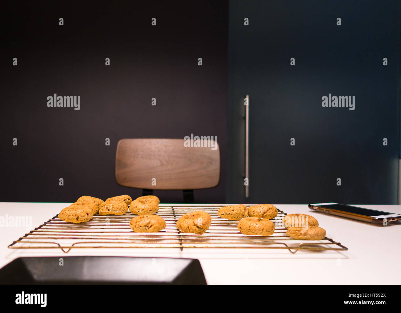 Backen in einem dunklen grau ummauerten Küche mit Donuts auf Rack-Kühlung Stockfoto