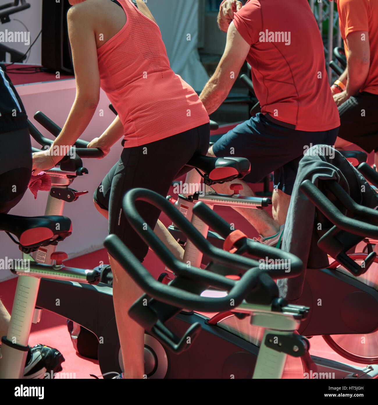 Gruppe von jungen und Mädchen in der Turnhalle: Workout mit Spinning-Bikes Stockfoto