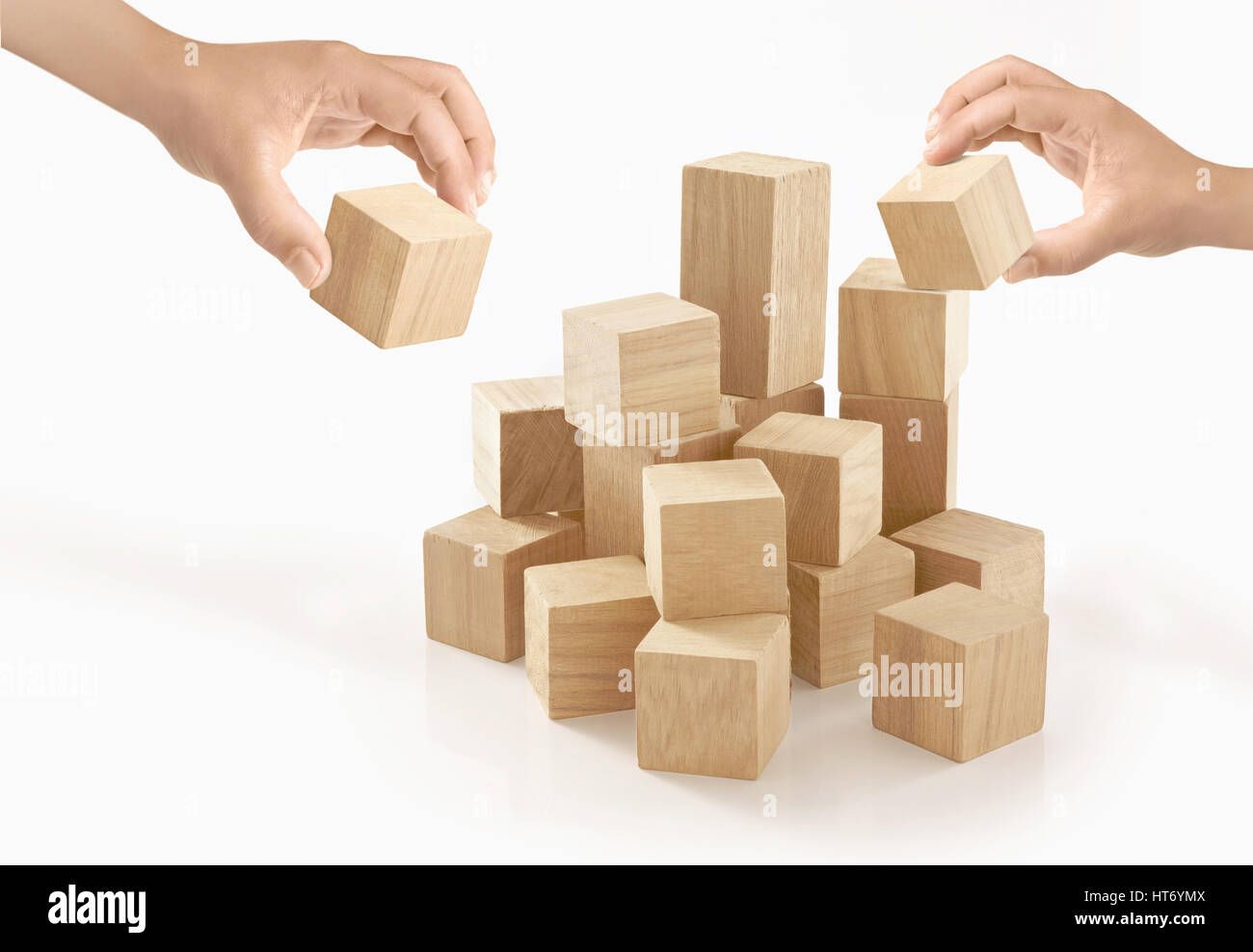 Zwei Hände spielen Holzkiste auf isolierte Hintergrund. Stockfoto
