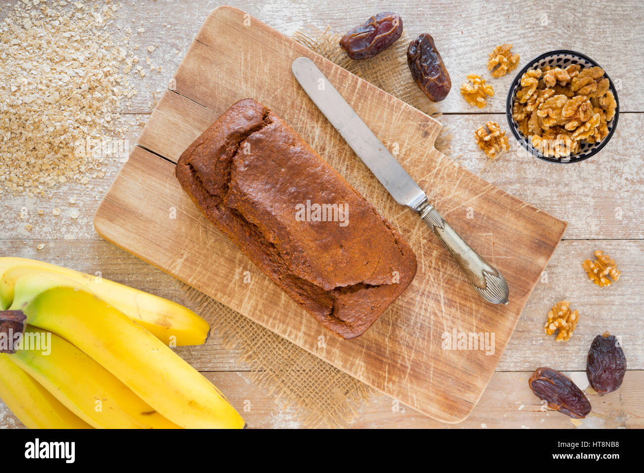 Hausgemachte Bananenbrot mit Walnüssen und Termine auf einem rustikalen Tisch. Stockfoto