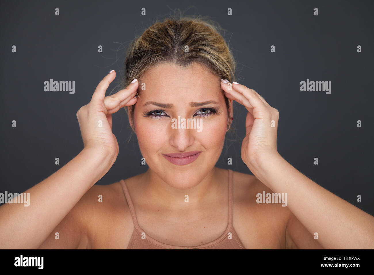 Frau, massieren ihren Kopf mit ihren Fingern, weil sie Kopfschmerzen hat. Stockfoto