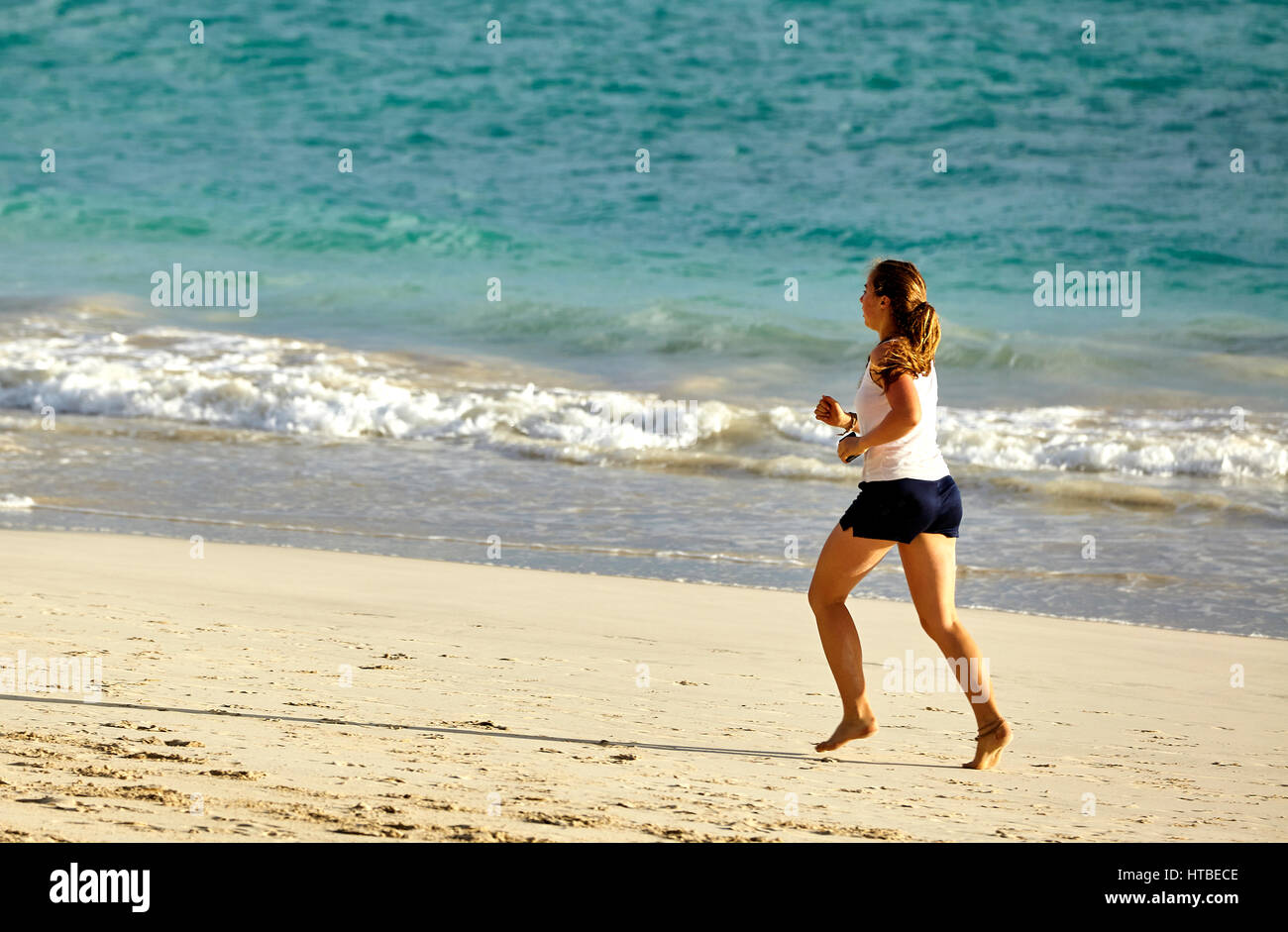 Kailua, Hawaii, USA - 30. Juli 2016: Eine Unidentifed Frau läuft am Sandstrand entlang den Ufern der Kailua Bay auf Hawaii Stockfoto