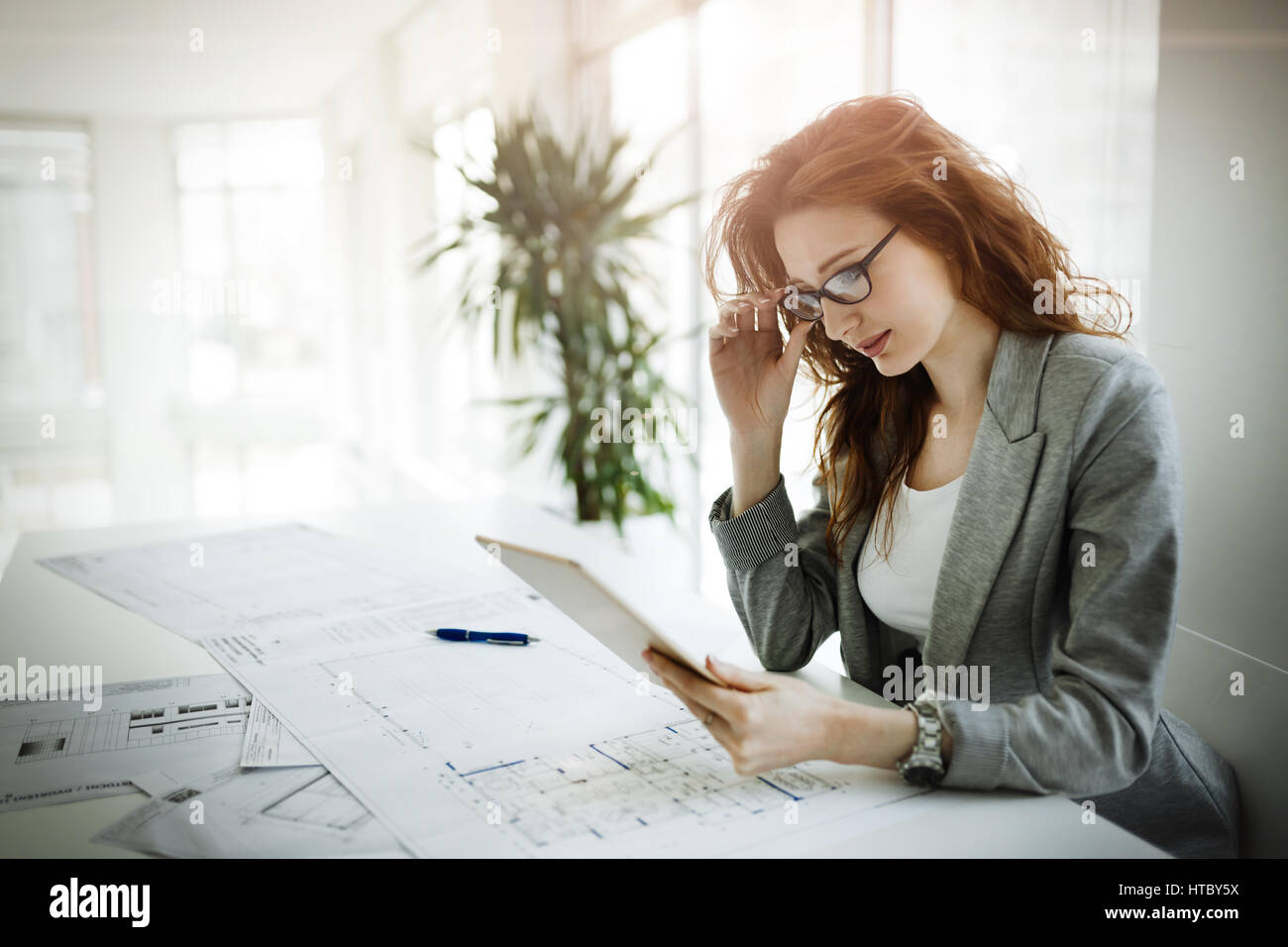 Schönen weiblichen Architekten arbeitet an Plan im Firmensitz Stockfoto