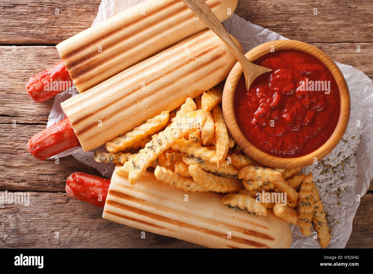 Würzige französischen Hot-Dog Brötchen mit Pommes und Ketchup Closeup auf dem Tisch. horizontale Ansicht von oben Stockfoto