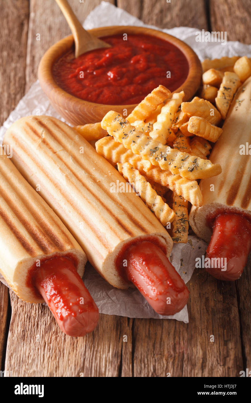 Köstliche französische Hot-Dog Brötchen mit Pommes und Ketchup Closeup auf dem Tisch. vertikale Stockfoto