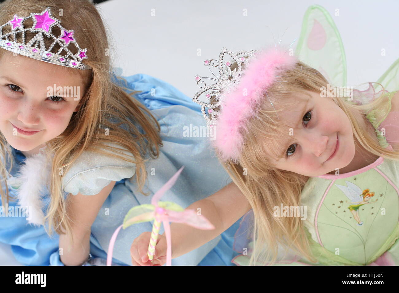 Disney Cinderella & Tinkerbell Kostüme. Kleine Mädchen Kinder gekleidet in  Prinzessin Kleider und Kronen, unschuldige Konzept, Kindheit Konzept  Stockfotografie - Alamy