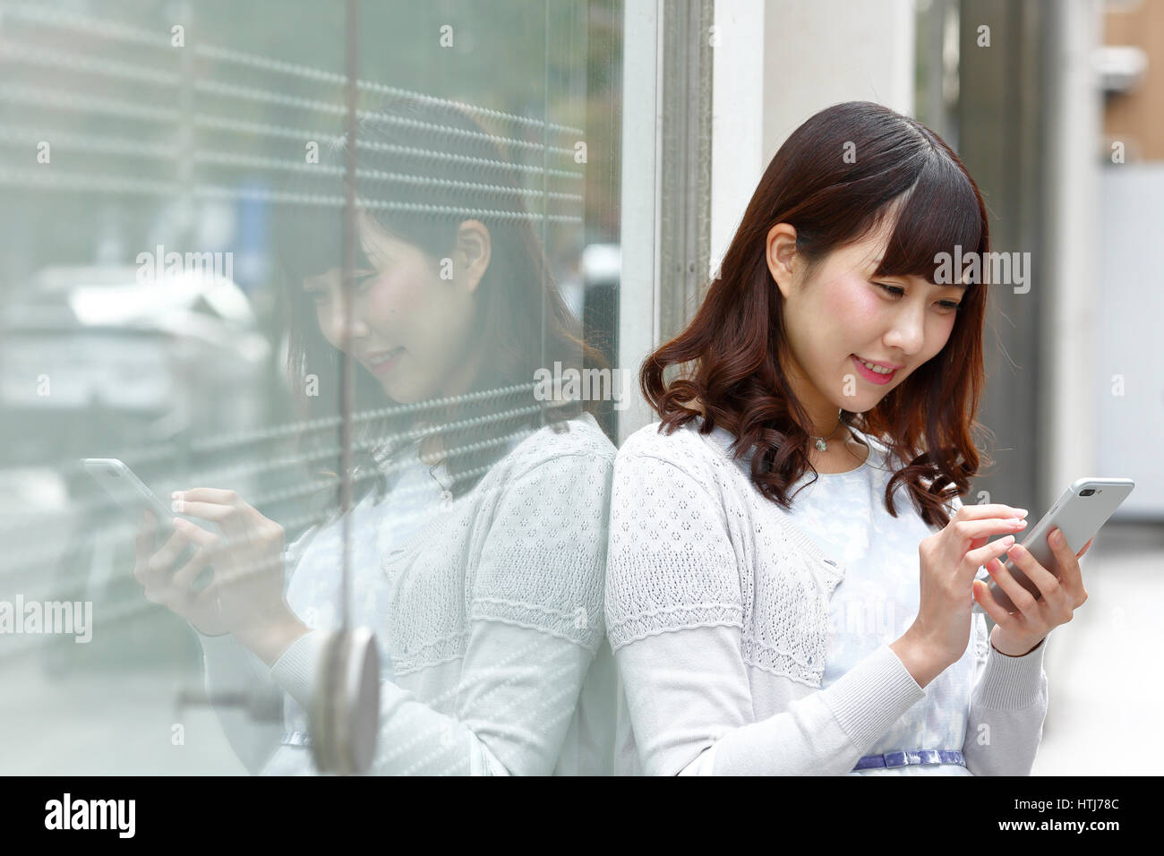 Modische Japanerin mit Smartphone in Luxus Raum Tokio, Tokio, Japan Stockfoto