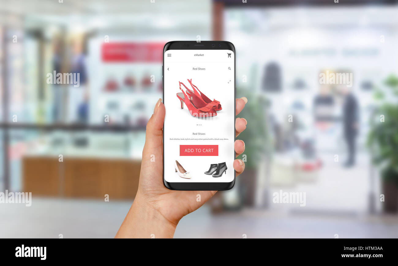Frau roten Schuhe online mit Handy kaufen. E-shopping mit Website oder App Kleidung und Schuhe shop im Hintergrund. Stockfoto
