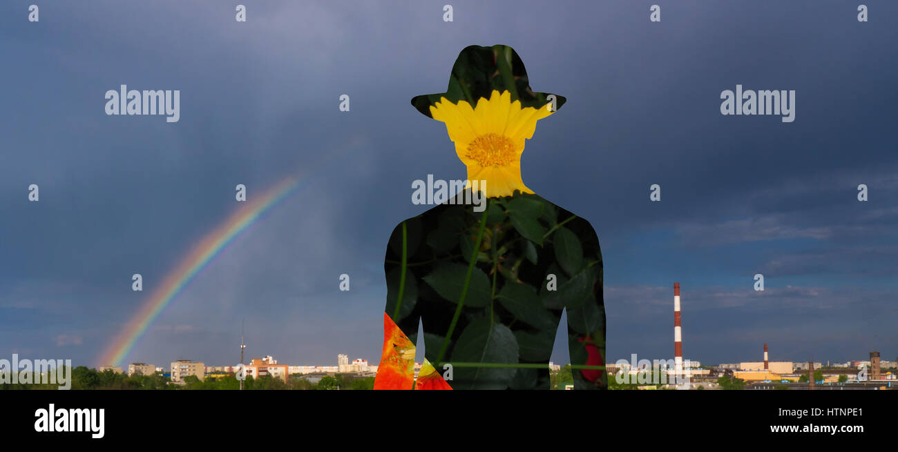 Silhouette eines Mannes vor dem Hintergrund der einen Regenbogen und einem Kamin. Stockfoto