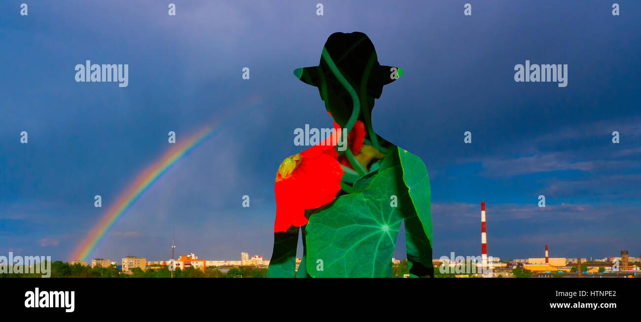 Silhouette eines Mannes vor dem Hintergrund der einen Regenbogen und einem Kamin. Stockfoto