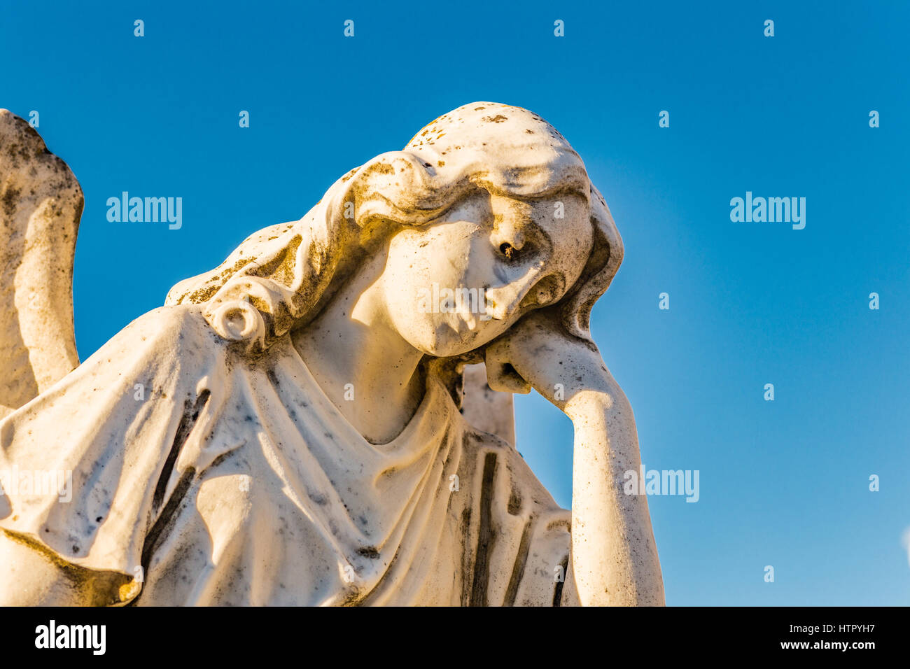 Statue von traurig und betrübt Engel blickte und Erhaltung ihrer geneigten Kopf mit hand Stockfoto