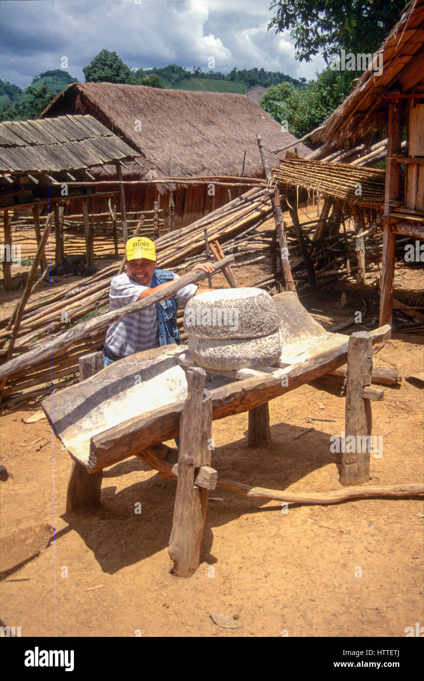 Kriegszeit Mörtel verwendet, um die Schale Reis in einem Hmong Dorf auf Plain of Jars, einer Landschaft, gezeichnet von Bombe Krater und Landminen, Xieng Khouang, Laos. Stockfoto