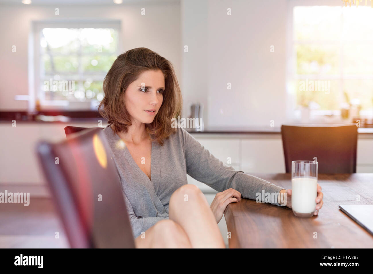 Junge Frau sitzt am Tisch im Speisesaal Stockfoto