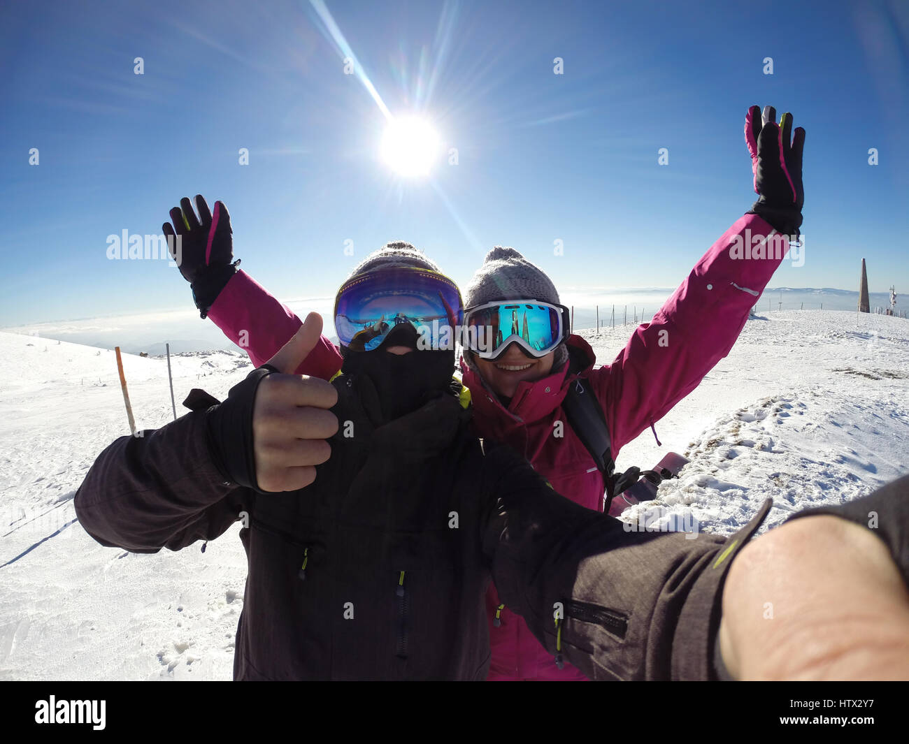 Glücklich männliche und weibliche Skifahrer in den verschneiten Bergen Stockfoto