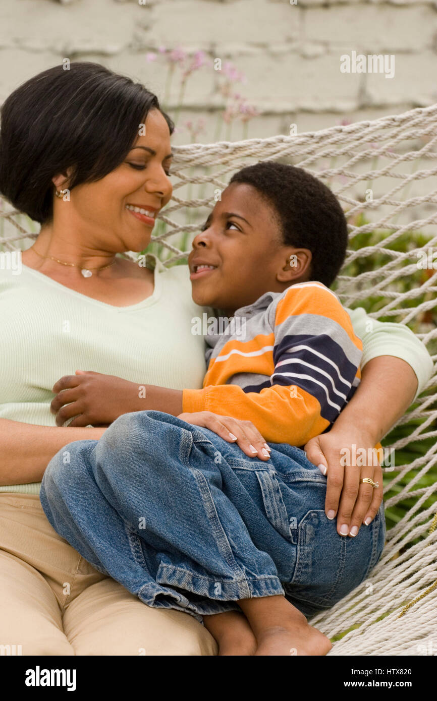 Mama und ihr Sohn in einer Hängematte entspannen. Stockfoto