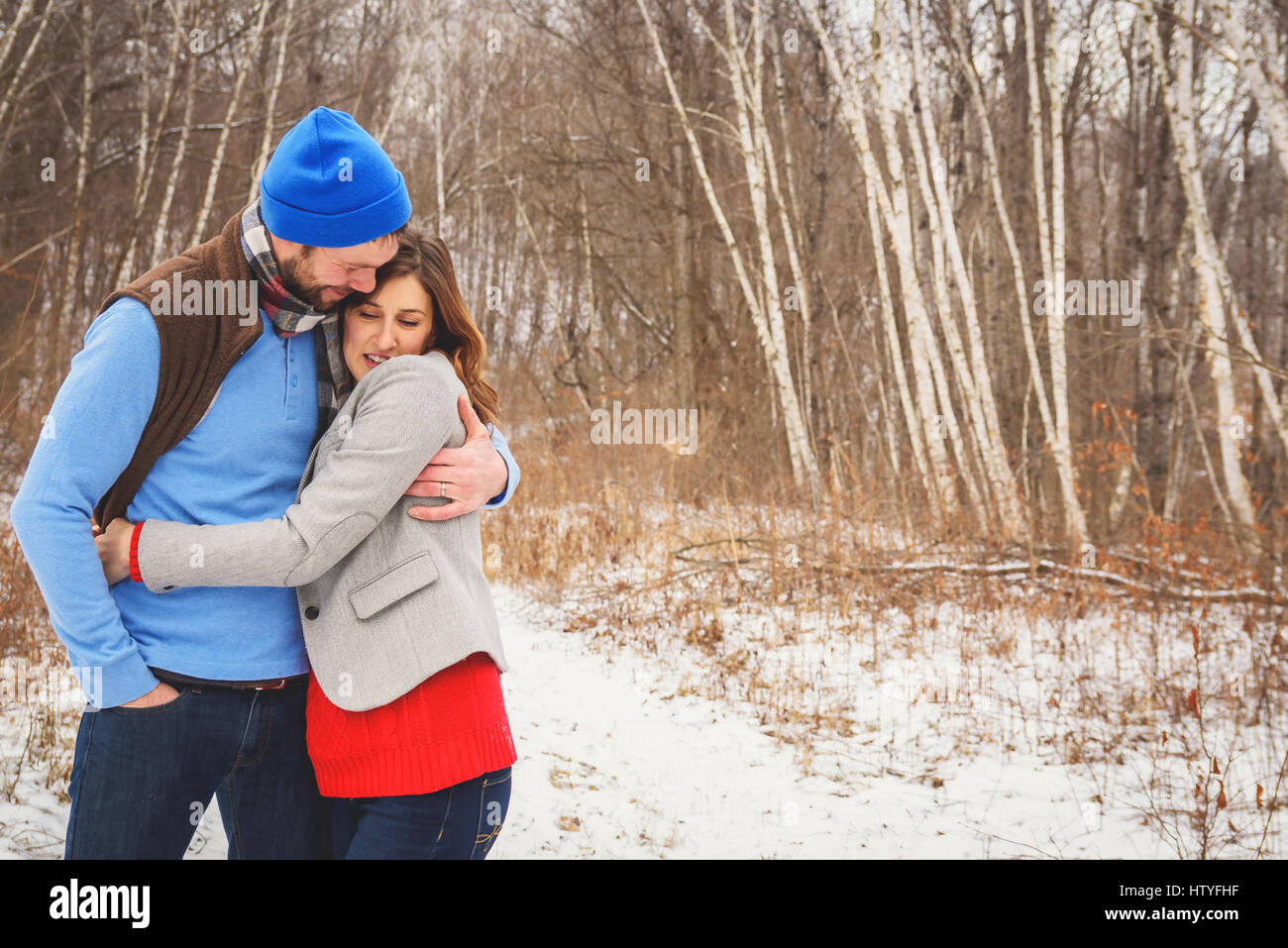Mann und Frau im Schnee umarmt Stockfoto