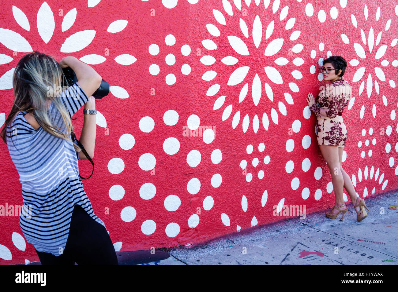 Miami Florida, Wynwood, städtische Graffiti, Street Art, bemalte Wandmalerei, Frau weibliche Frauen, Fotografin, Modell, Posen, Fotoshooting, rot, FL170122043 Stockfoto