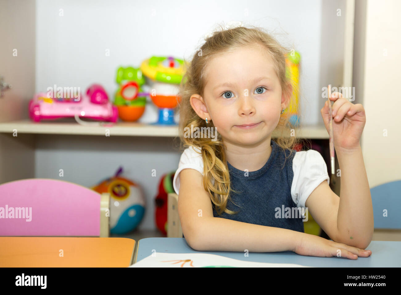 Entzückenden Kind Mädchen zeichnet einen Pinsel und malt im Kinderzimmer. Kind in den Kindergarten in Montessori-Vorschule. Stockfoto