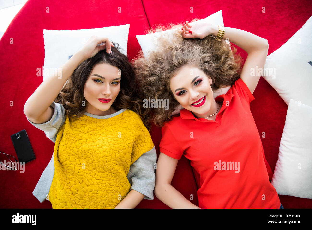 Draufsicht der zwei Lächeln Freunde Frauen Om Sofa liegend Stockfoto