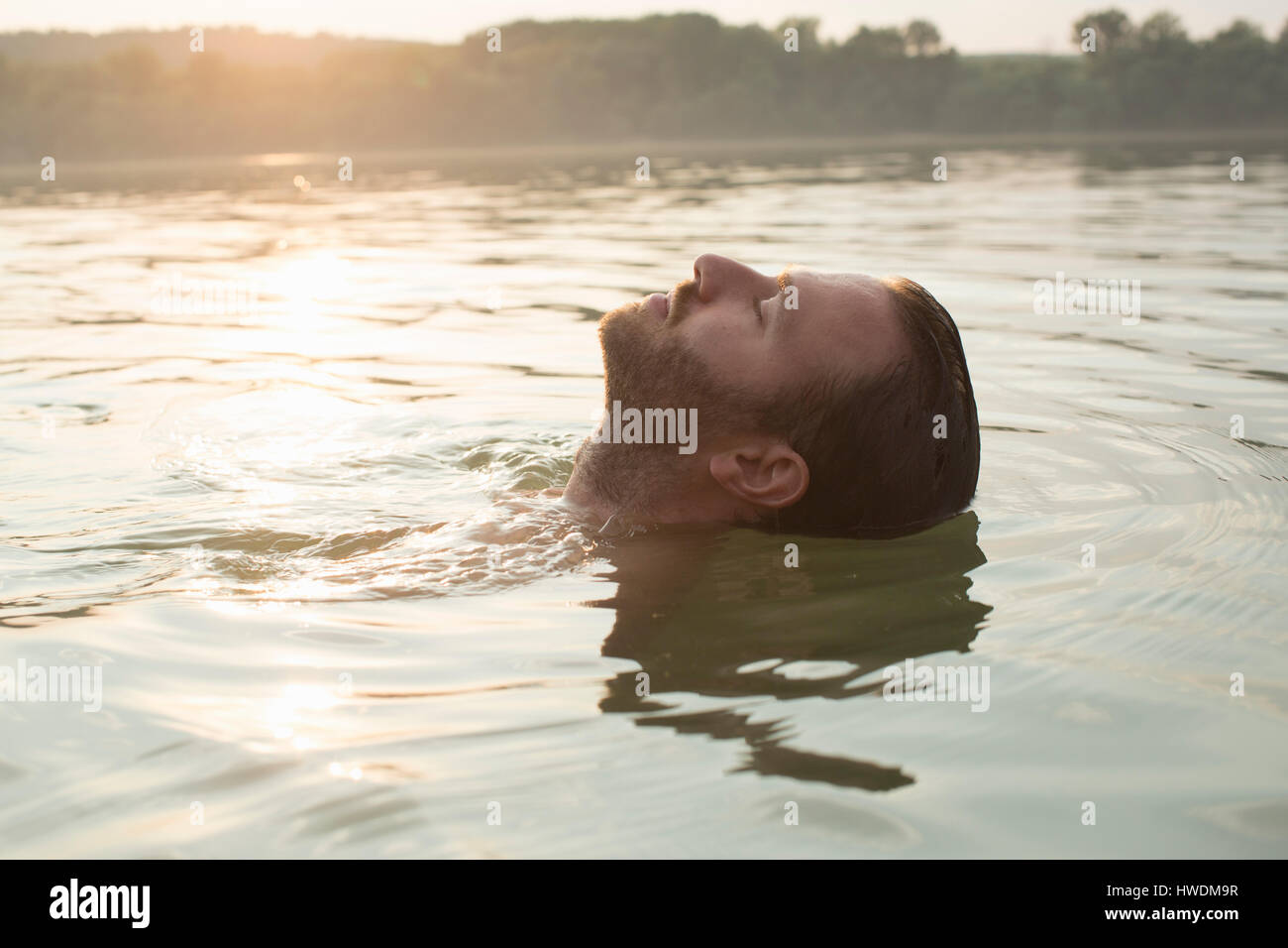 Mann, entspannend, Schwimmen im Fluss Stockfoto