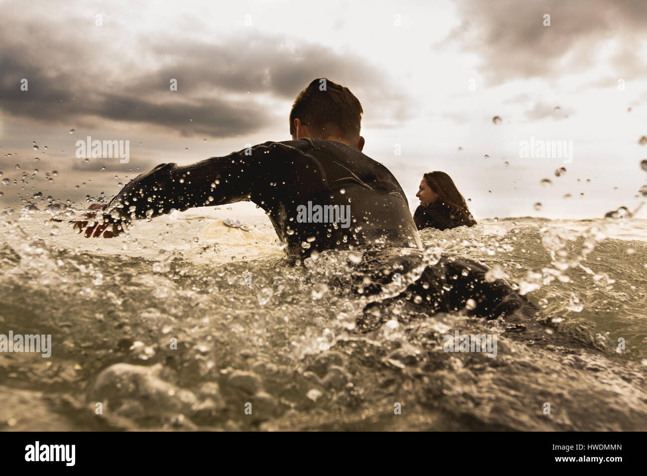 Zwei Freunde im Meer paddeln auf Surfbretter, Rückansicht Stockfoto