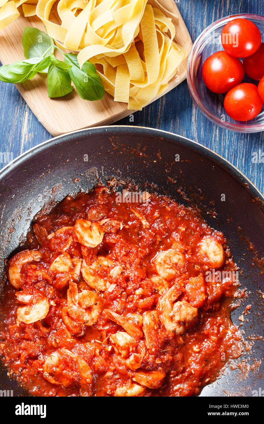 Garnelen Sie mit Tomatensauce und Kräutern auf einer Pfanne. Italienische Küche. Ansicht von oben Stockfoto