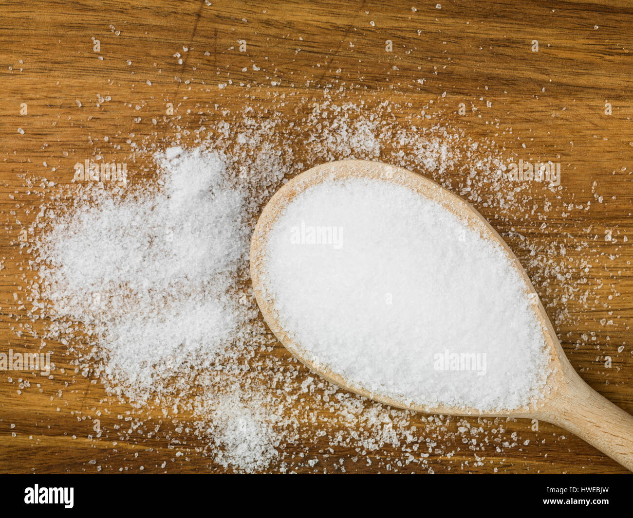 Hölzerne Löffel feines Salz vor dem natürlichen Holz Hintergrund Stockfoto