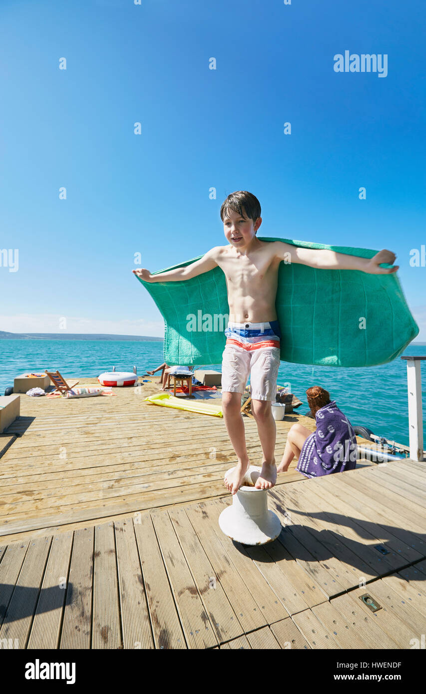 Junge, balancieren auf Liegeplatz Post auf Hausboot Sonnendeck, Kraalbaai, Südafrika Stockfoto