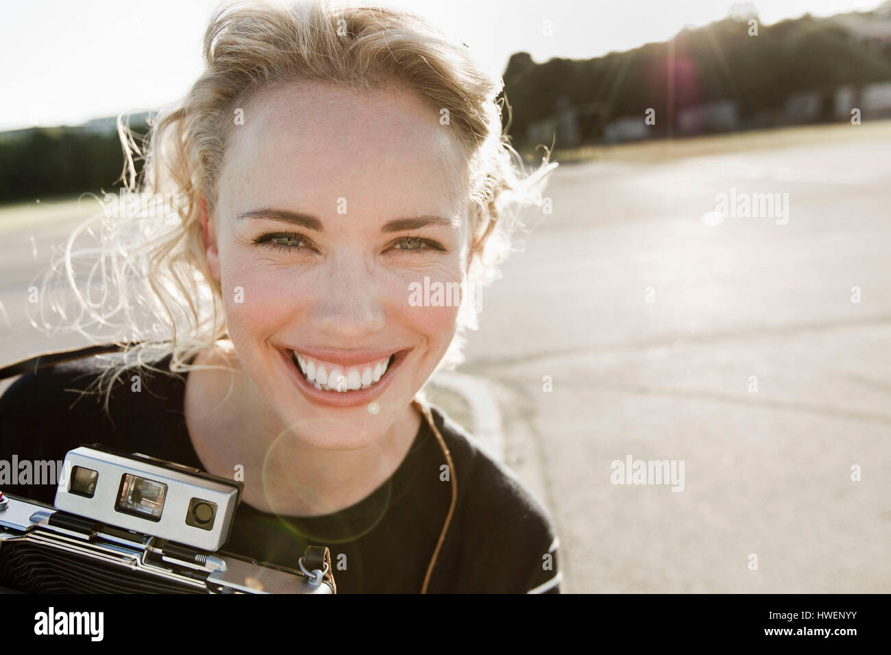 Porträt von glücklich Mitte Erwachsene Frau mit Vintage-Kamera Stockfoto