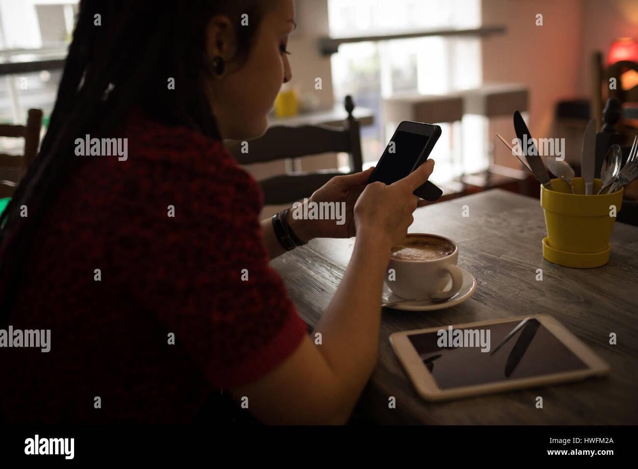 Schöne Frau mit Handy in CafÃƒÂ © Stockfoto